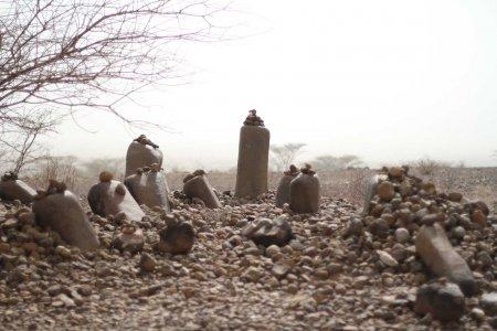 Stone pillars at Namoratunga in Turkana, Kenya, surrounded by small rock piles, believed to be part of an ancient astronomical and cultural site.