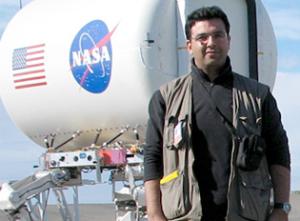 Picture of Essam Heggy standing in front of NASA JPL